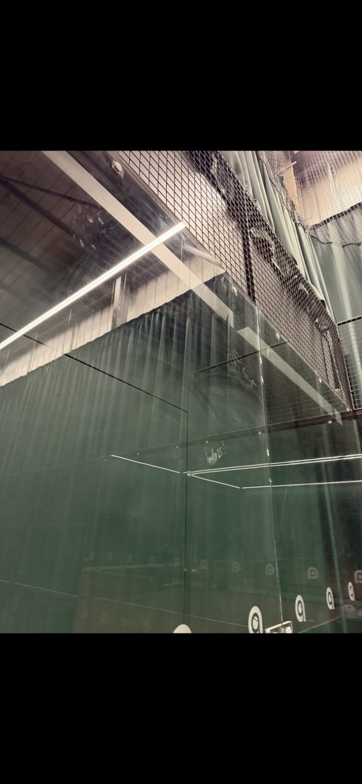 Marked padel court glass before cleaning